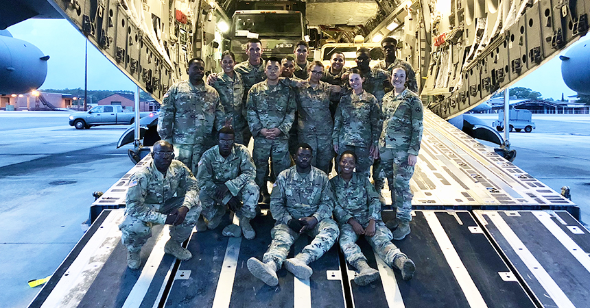 Valerie posing on a military aircraft