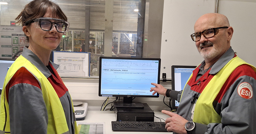 Martial and a co-worker at a workstation