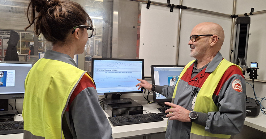 Martial talking to a co-worker while looking at a computer screen
