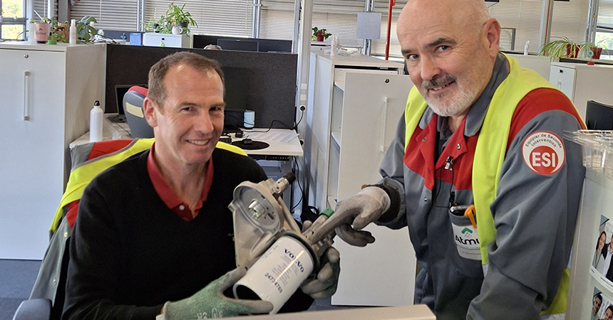 Martial and a co-worker holding a product